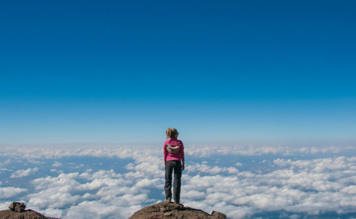 Woman Standing on the edge of Kilimanjaro Summit