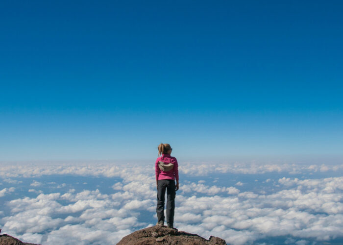 Woman Standing on the edge of Kilimanjaro Summit