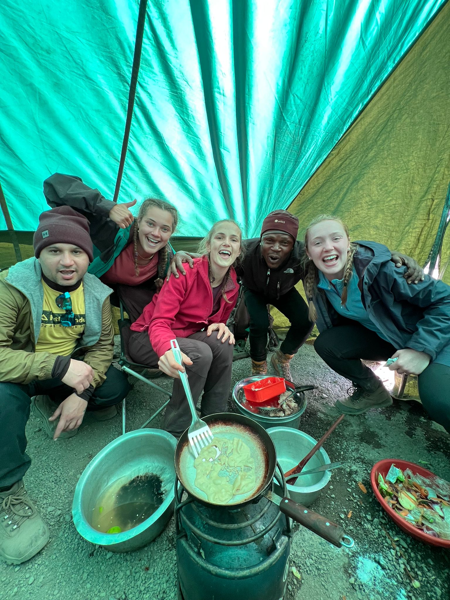 Alice, Diane, Amit, Rhiannon and Louise cooking on Kilimanjaro