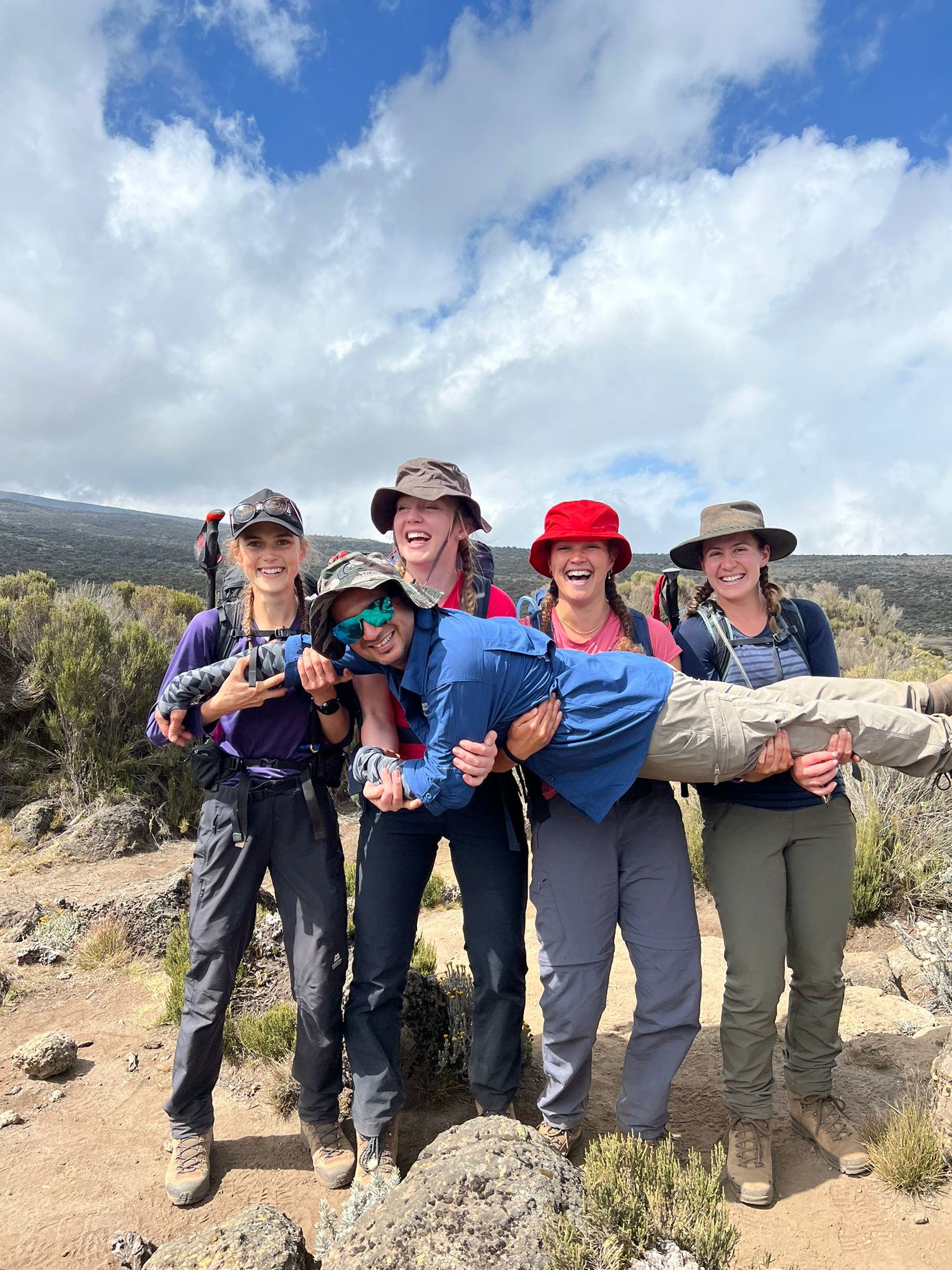 Alice, Rhiannon, Diane and Louise carrying Amit on Kilimanjaro